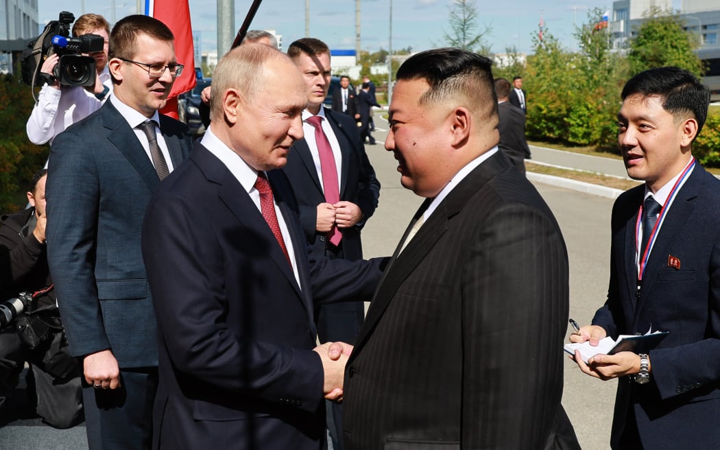In this pool photo distributed by Sputnik agency, Russia's President Vladimir Putin (Centre L) shakes hands with North Korea's leader Kim Jong Un (2nd R) during their meeting at the Vostochny Cosmodrome in Amur region on September 13, 2023. Russian President Vladimir Putin and North Korean leader Kim Jong Un both arrived at the Vostochny Cosmodrome in Russia's Far East, Russian news agencies reported on September 13, ahead of planned talks that could lead to a weapons deal. (Photo by Vladimir SMIRNOV / POOL / AFP)
