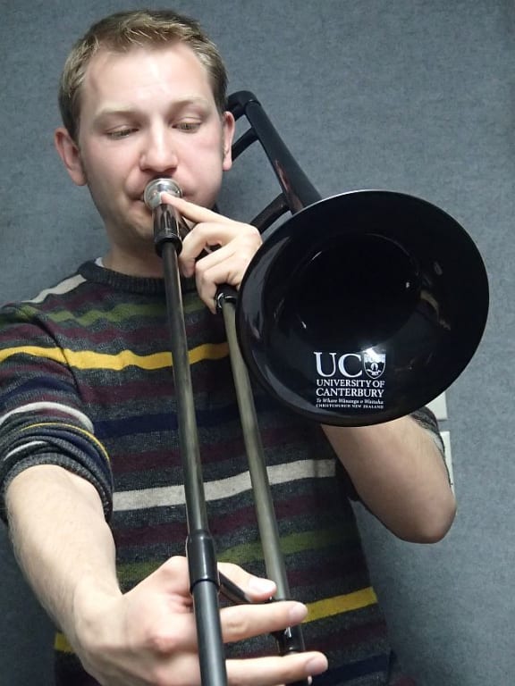 PhD student Matthias Heyne plays the 'Pbone' plastic trombone that all the study participants performed on for the study.
