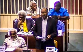 Vanuatu prime minister Charlot Salwai (standing) defends his policies during debate for a parliamentary motion of confidence tabled against him by the opposition, 19 December 2017.