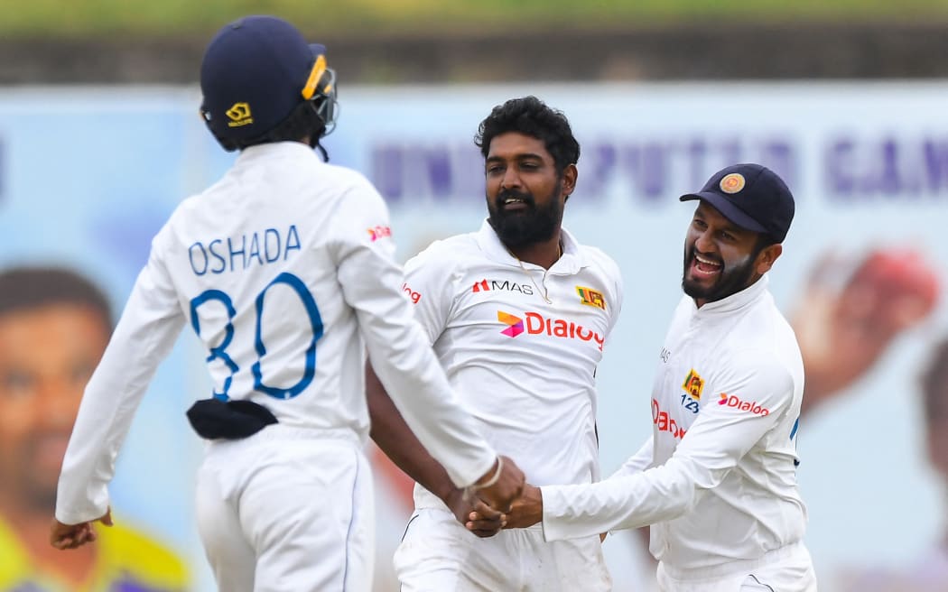Sri Lanka's Prabath Jayasuriya, centre, celebrates with teammates after taking the wicket of Australia's Usman Khawaja (not pictured) during the fourth day of the second cricket Test match between Sri Lanka and Australia at the Galle International Cricket Stadium in Galle on 11 July 2022.