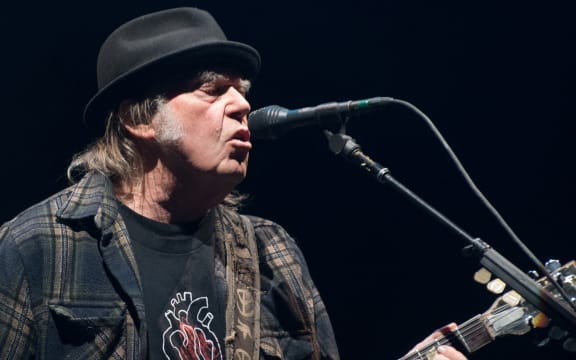 In this file photo taken on 7 July 2018 Neil Young performs on stage for his first time in Quebec City during 2018 Festival d'Ete.