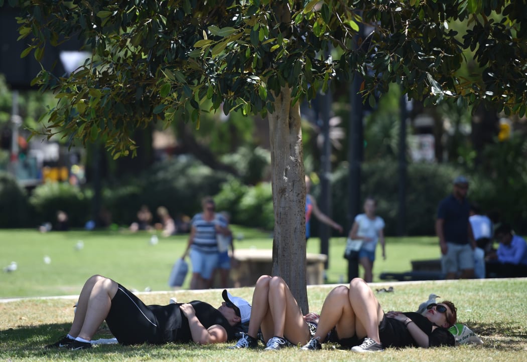 People shelter from the sun on a hot day in Sydney.