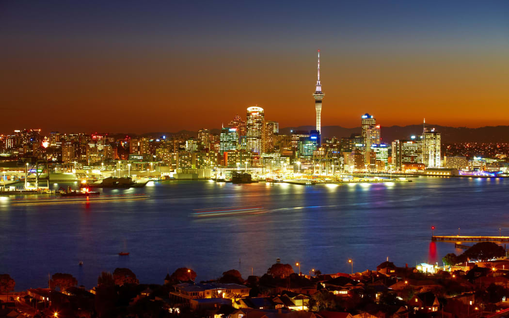 The Sky Tower and waterfront are lit by evening lights - as seen from Devonport on the North Shore.