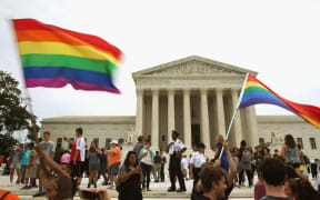 People celebrate in front of the US Supreme Court after the ruling in favor of same-sex marriage.