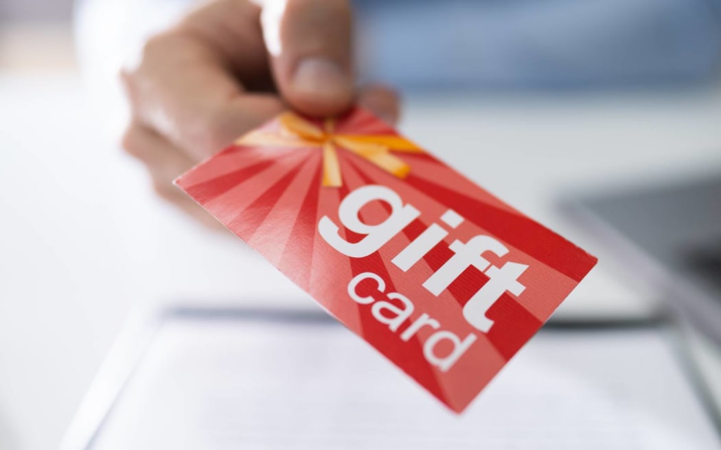 Close-up Of A Businessperson Hands Giving Gift Card