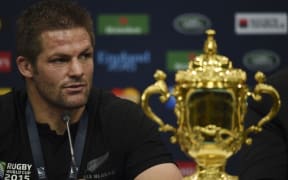 Richie McCaw with the Webb Ellis Cup into a post match press conference following the final of the 2015 Rugby World Cup between New Zealand and Australia at Twickenham.
