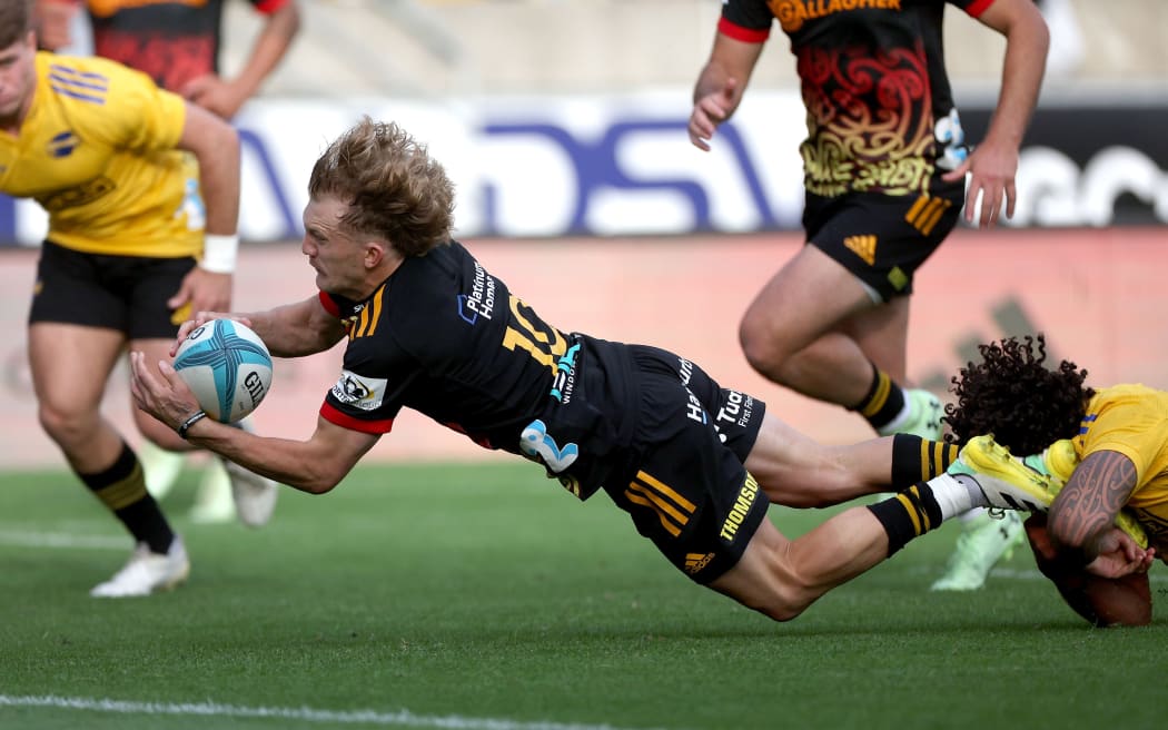 Chiefs' Damian McKenzie scores one of this side's three second half tries against the Hurricanes.