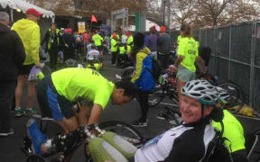 Ian Winson on his foot powered tricycle wheelchair surrounded by crowds a the New York Marathon