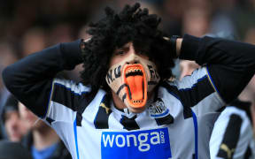 Premier League - A Newcastle fan wearing an angry mask.