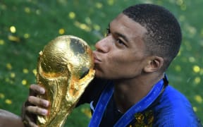 France's forward Kylian Mbappe kisses the trophy after the team's 4-2 win over Croatia in the Russia 2018 World Cup final at the Luzhniki Stadium in Moscow.