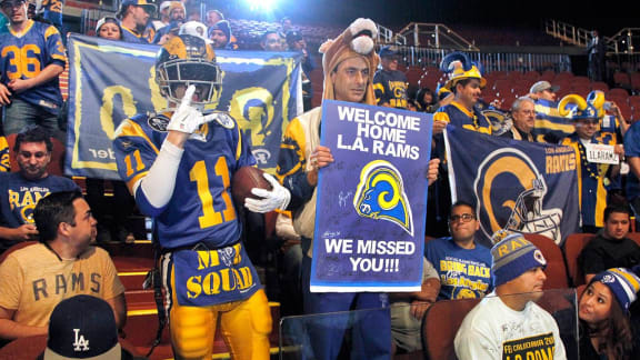 Los Angeles Rams fans cheer for the NFL football team at a news conference