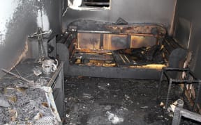 Fire extinguished at 4 minutes, shows a lack of structural damage. Prime contributor to heat, flames, smoke and gases was the polyurethane foam of the sofa.