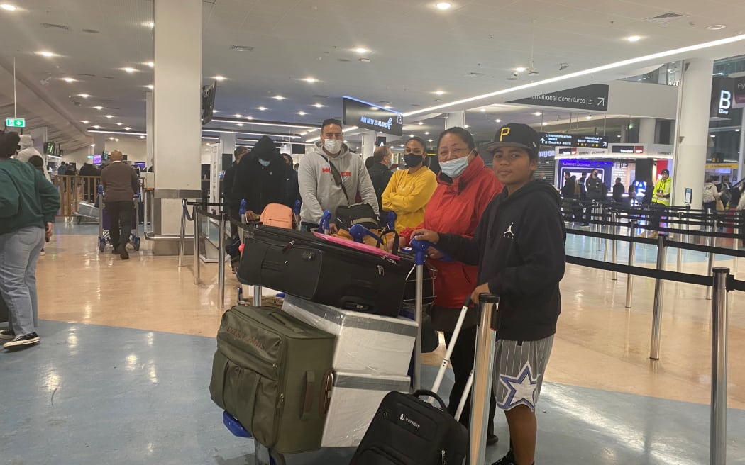 Passengers pose at the airport after Niue reopens its border.