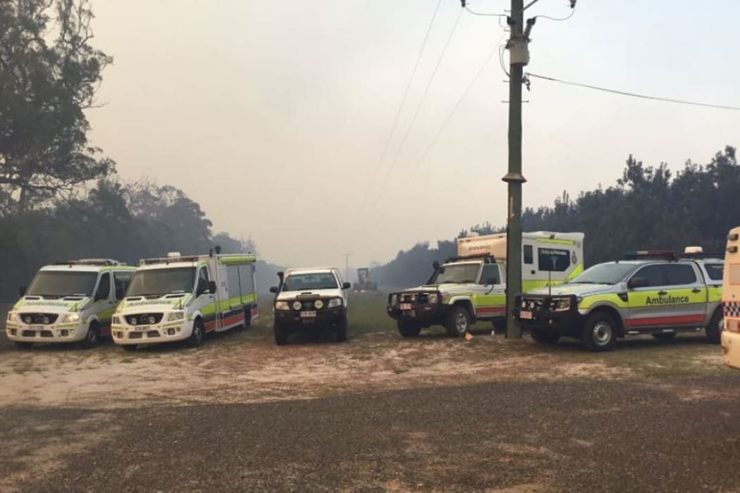 Ambulance vehicles at Deepwater, where a large fire is burning.