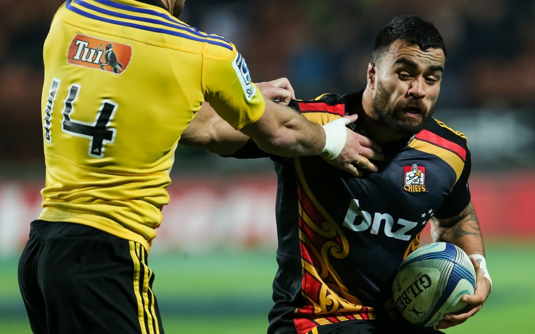 Chiefs captain Liam Messam fends off Hurricanes' Cory Jane during the Super 15 Rugby match at Waikato Stadium, Hamilton, in July.