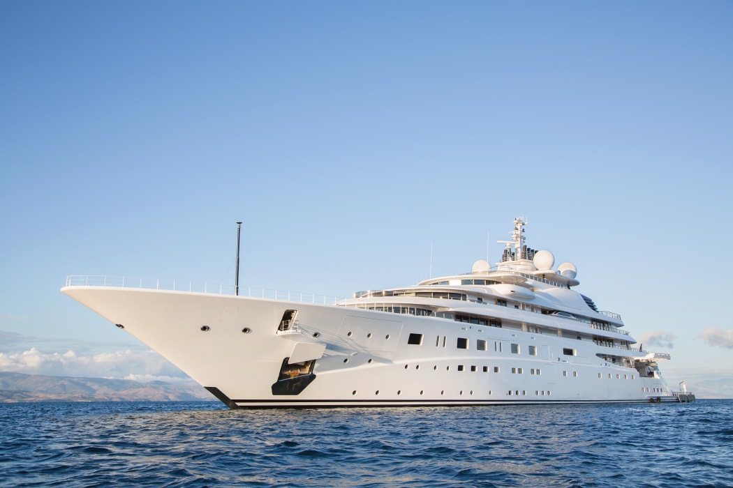 Gigantic big and large luxury mega or super motor yacht on the blue ocean.