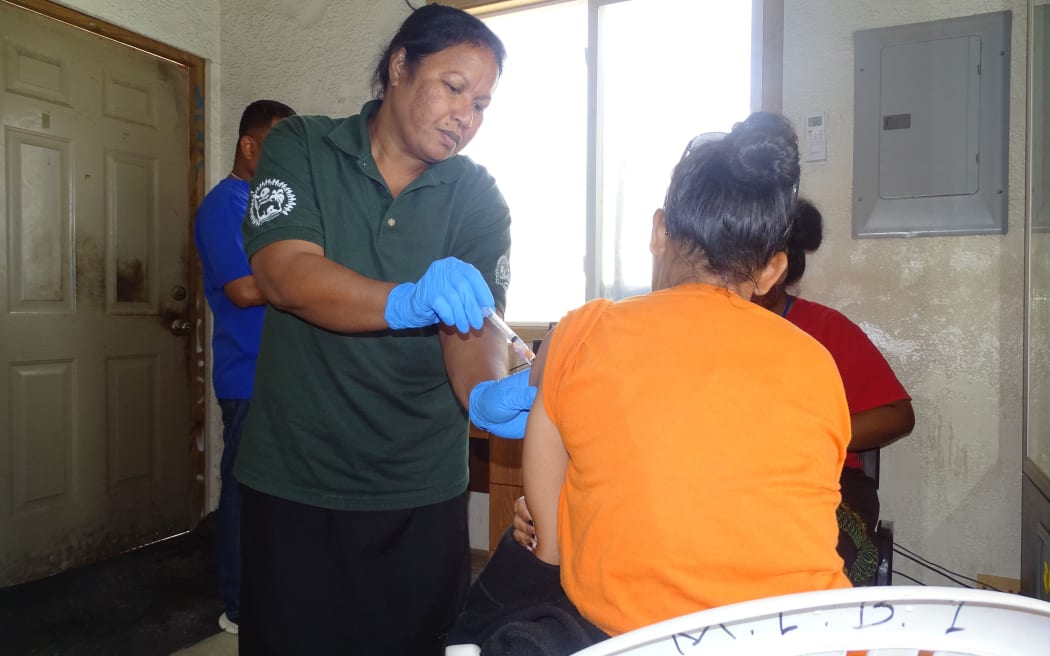 Public Health nurse Ruth Andrew administers a Covid vaccine shot in Majuro during a house-to-house outreach program to distribute vaccines.