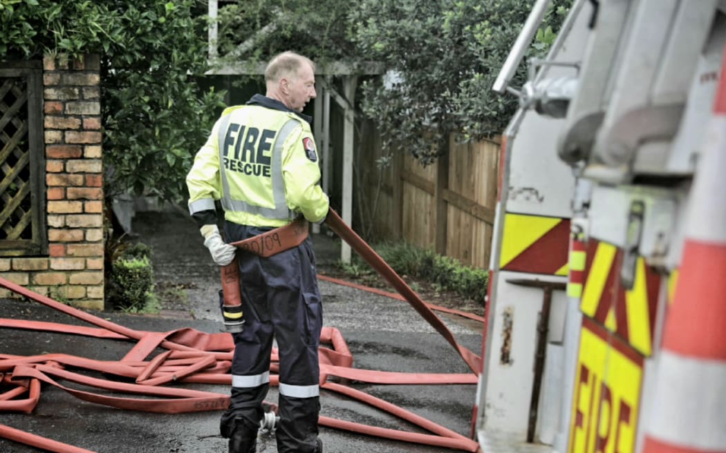 Fire and Emergency pump out water from a property on Grove Road in Auckland's Devonport on 1 February following flooding.