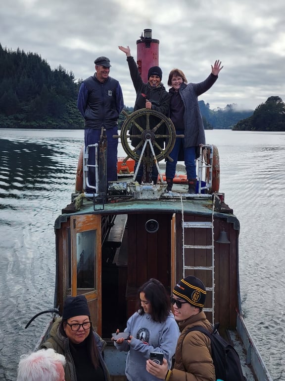 Volunteer project lead Steve McClune, Ariana Paul and Whanganui Riverboat Restoration and Navigation Trust chair Marion Johnston on head for the slip from the recovery site. Photo/Supplied