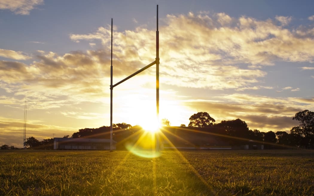 14437716 - goal posts for football, rugby union or league on field at sunset