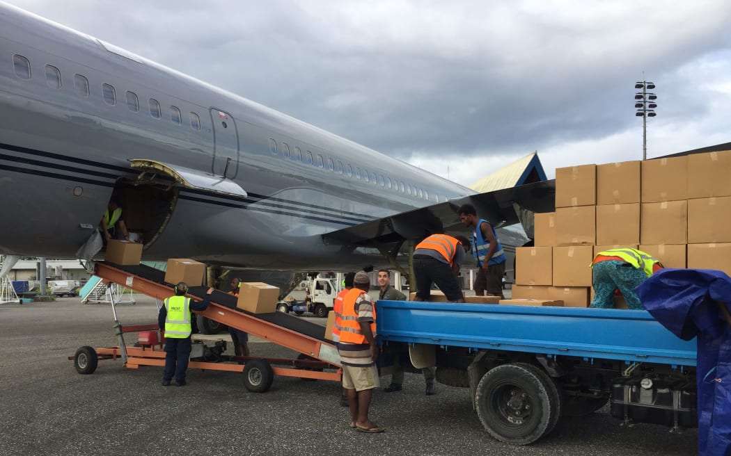 Crew from the RNZAF’s No.40 Squadron, help offload about voting equipment and operational supplies in Solomon Islands
