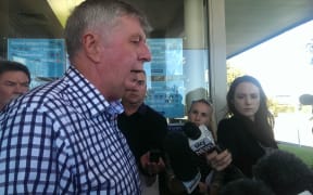 Maurice Williamson talks to reporters outside his electorate office in Auckland.