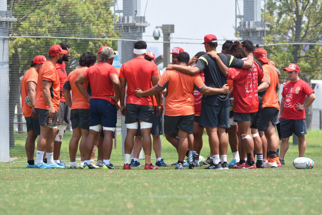 The 'Ikale Tahi players huddle together during training in Japan.