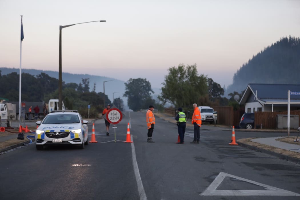 Emergency services guard a cordon in Wakefield township, where residents have been asked to be prepared to leave at a moment's notice.