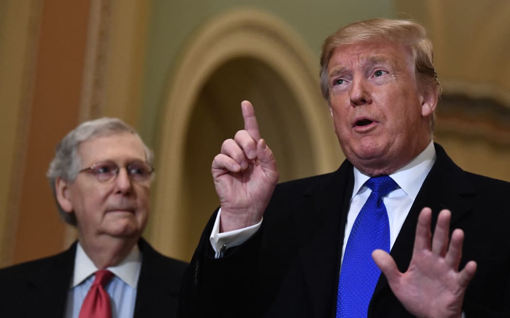 US President Donald Trump speaks to the press alongside Senate Majority Leader Mitch McConnell as he arrives on Capitol Hill March 26, 2019 before joining Senate Republicans for lunch in Washington, DC .  (Photo by Brendan Smialowski / AFP)