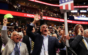 Former Virginia Attorney General Ken Cuccinelli, left, along with other delegates from Virginia chant for a rule call vote on the first day of the Republican National Convention.