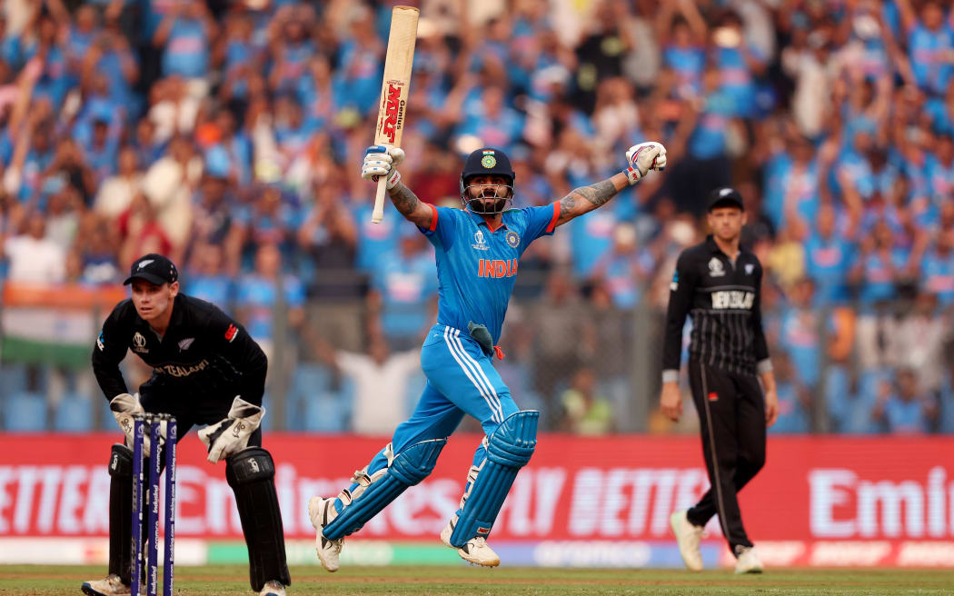 Virat Kohli of India celebrates after scoring a century, overtaking Sachin Tendulkar for the all time most ODI centuries during the ICC Men's Cricket World Cup India 2023 Semi Final match between India and New Zealand at Wankhede Stadium.