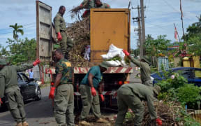 Soldiers help clean up in the capital Suva.
