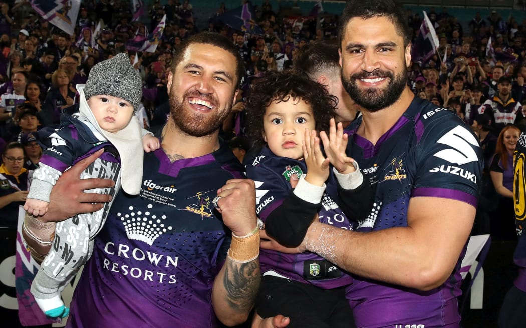 New Zealand brothers Kenny and Jesse Bromwich celebrate Melbourne's NRL grand final win.