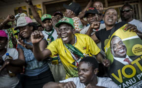 Supporters of the newly reelected Zimbabwe President Emmerson Mnangagwa, celebrate in Mbare, a district of the Zimbabwe's capital Harare.