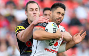 Shaun Johnson is tackled by Penrith's Isaah Yeo.