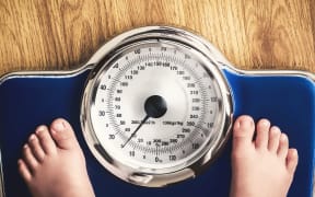 kids feet on weight scale - childhood obesity