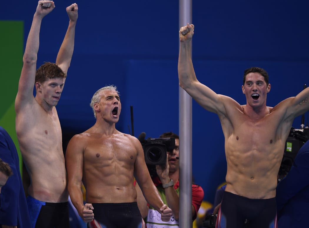 US swimmers Townley Haas, Ryan Lochte and Conor Dwyer celebrate after winning the Men's 4x200m Freestyle Relay Final at the Rio 2016 Olympic Games.