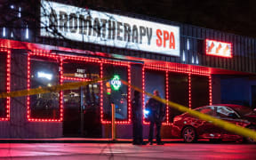 Law enforcement personnel are seen outside a massage parlor where a person was shot and killed on March 16, 2021, in Atlanta, Georgia.