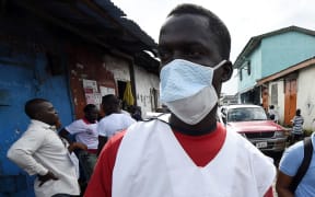 A Liberian health ministry employee visits the West Point district in Monrovia as part of an awareness campaign for Ebola.