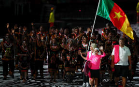 Cameroon's flagbearer Essiane Clotilde leads the delegation during the opening ceremony of the 2018 Gold Coast Commonwealth Games at the Carrara Stadium on the Gold Coast on April 4, 2018.