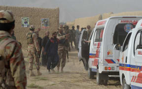 Pakistani Frontier Constabulary personnel gather in Mastung following a bomb blast at an election rally.