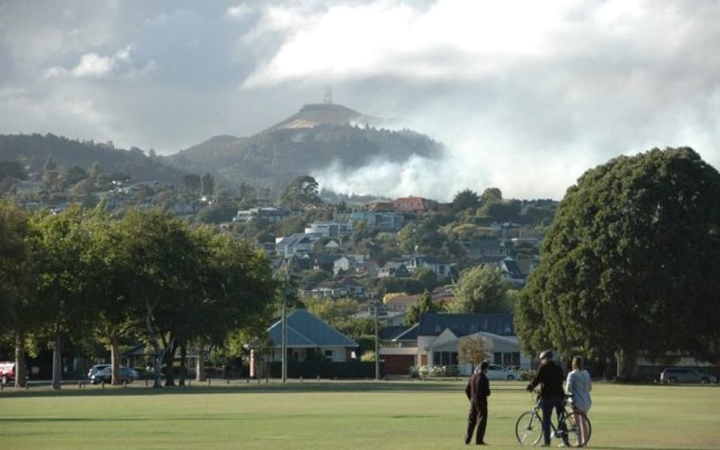 Locals watch the smoke rising from the huge fires overlooking Christchurch.