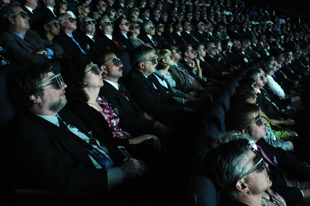 Movie goers watching a 3D film at an IMAX cinema