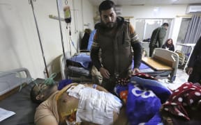 An injured man receives treatment at a hospital following a twin suicide bombing on a bustling commercial street in the heart of the Iraqi capital Baghdad, on January 21, 2021.
