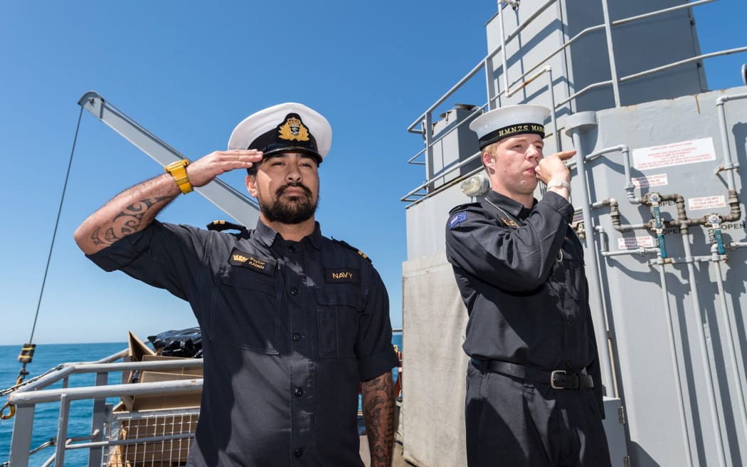 Members of the diving support team of HMNZS Manawanui performed a 'Piping of the Side' as a mark of respect when the men were recovered.