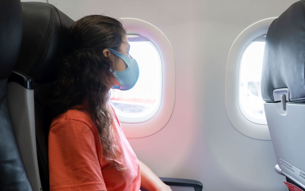 Masked woman during a flight
