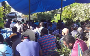Water Authority of Fiji workers wait outside the company's Kinoya station in the capital this morning.