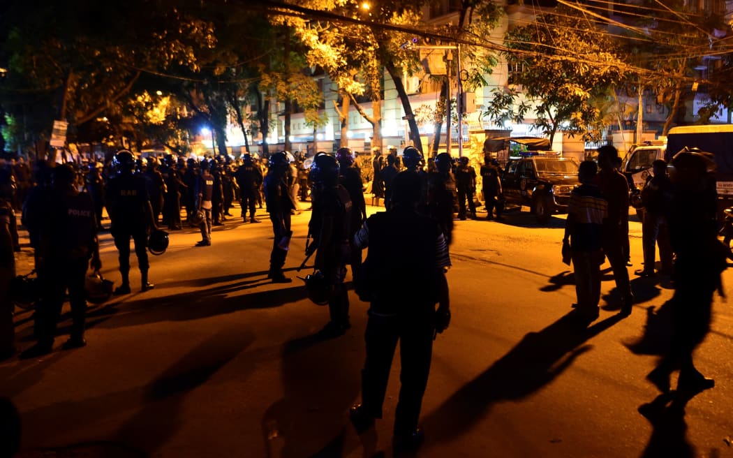 Bangladeshi security personnel stand guard outside a restaurant during an attack in Dhaka's high-security diplomatic district early on July 2, 2016.