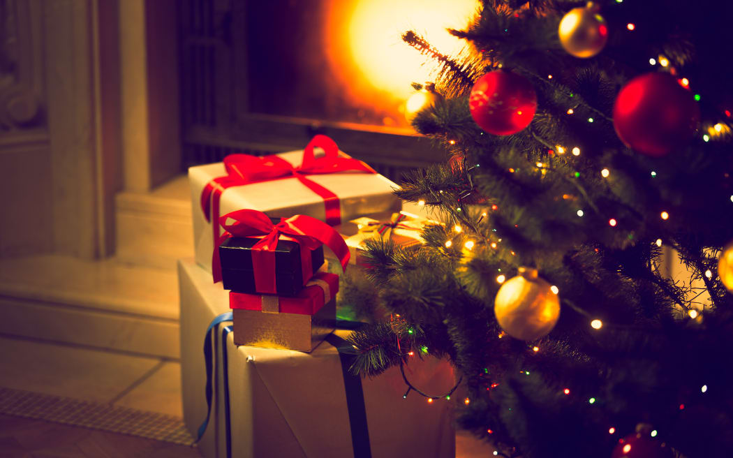 Christmas gifts wrapped under tree.