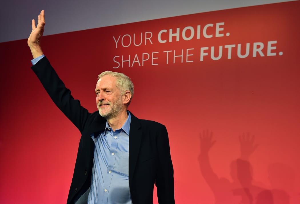 Jeremy Corbyn acknowledges the applause of the crowd as he stands on stage after being announced as the new leader of Britain's opposition Labour party.